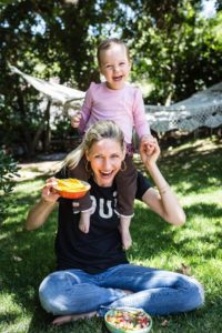 Mom and Daughter in Park Eating Mango